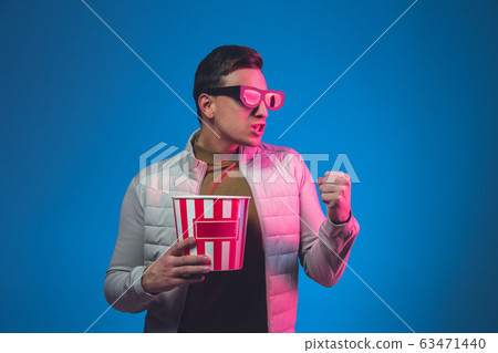 Caucasian man's portrait isolated on blue studio background in neon light Caucasian man's portrait isolated on blue studio background in neon light 63471440