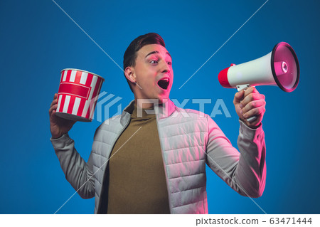 Caucasian man's portrait isolated on blue studio background in neon light Caucasian man's portrait isolated on blue studio background in neon light 63471444
