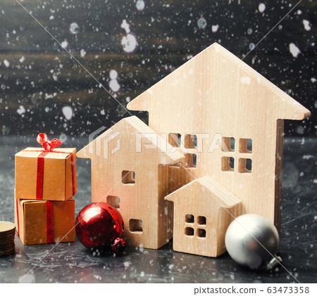 Wooden houses and gifts. Christmas Sale of Real Estate. New Year discounts for buying housing. Purchase apartments at a low price. Winter resort and vacation. Holiday discounts 63473358