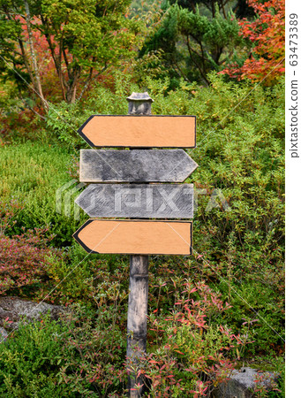 Wooden signboard in ornamental garden 63473389