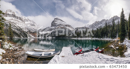 Panorama of Lake O'hara with canoe in wooden dock 63473450