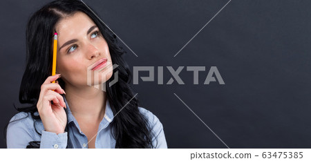 Young woman in a thoughtful pose 63475385