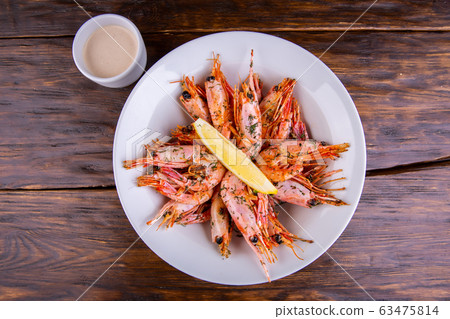 Seafood with finely cut greens and lemon Seafood with finely cut greens and lemon 63475814