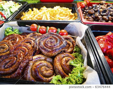 Bavarian sausages and tomatoes on the cafe menu. 63476444