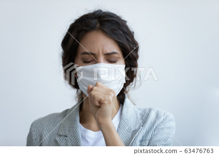Unhealthy woman in mask coughing having coronavirus disease symptoms Unhealthy woman in mask coughing having coronavirus disease symptoms 63476763