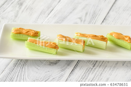 Celery stalks with peanut butter Celery stalks with peanut butter 63478631