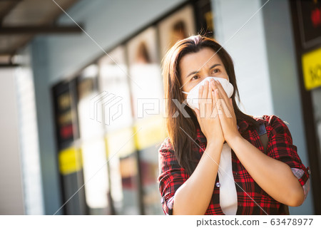Close up of a woman in a suit wearing Protective face mask 63478977