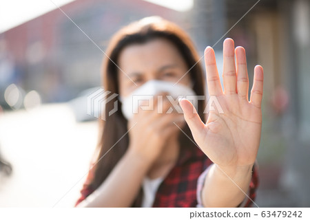 Close up of woman wearing protective face mask Close up of woman wearing protective face mask 63479242