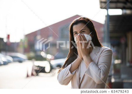 Close up of a businesswoman in a suit wearing Protective face mask 63479243