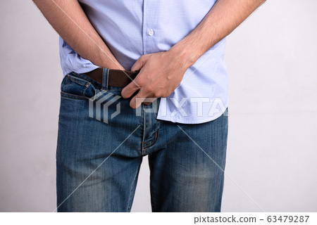 A young man suffering from prostatitis 63479287