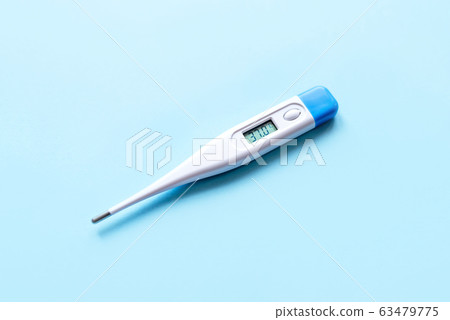 Close-up medical thermometer on blue background. 63479775