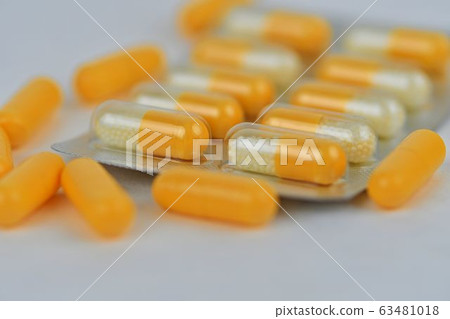 Colorful of capsules pill in blister packaging arranged with flare light. Pharmaceutical industry concept. Pharmacy drugstore. Antibiotic drug resistance. Colorful of capsules pill in blister packaging arranged with flare light. Pharmaceutical industry concept. Pharmacy drugstore. Antibiotic drug resistance. 63481018