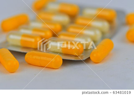 Colorful of capsules pill in blister packaging arranged with flare light. Pharmaceutical industry concept. Pharmacy drugstore. Antibiotic drug resistance. 63481019