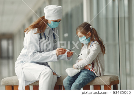 Doctor and a child in protective masks are in hospital 63485060