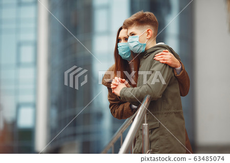 Mother and son are wearing disposable masks 63485074