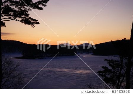 Iwate mountain at sunset seen from frozen rocky lake Iwate mountain at sunset seen from frozen rocky lake 63485898