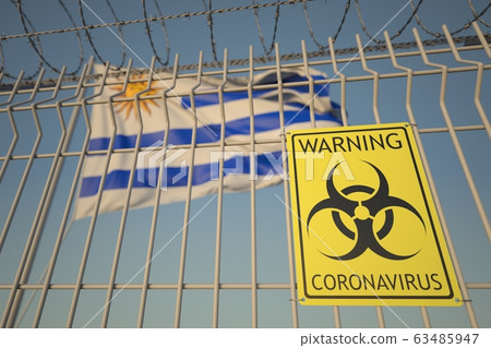 Coronavirus biohazard sign on the fence against the Uruguayan flag. Quarantine in Uruguay, conceptual 3D rendering Coronavirus biohazard sign on the fence against the Uruguayan flag. Quarantine in Uruguay, conceptual 3D rendering 63485947