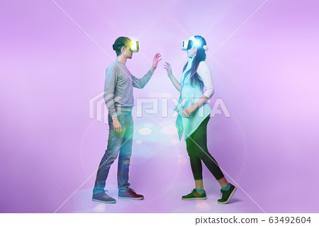 Couple in love communicate using a virtual reality headset. 63492604