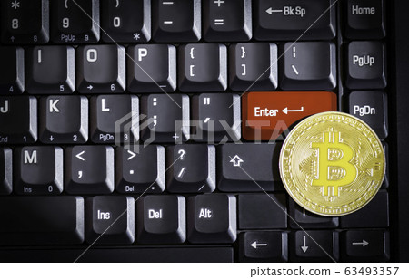 Bitcoin on red enter button computer keyboard background Bitcoin on red enter button computer keyboard background 63493357