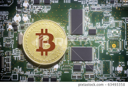 Bitcoin on green computer circuit board background Bitcoin on green computer circuit board background 63493358
