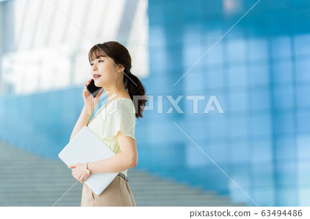 Business woman making phone call Business image Female employee Business woman making phone call Business image Female employee 63494486