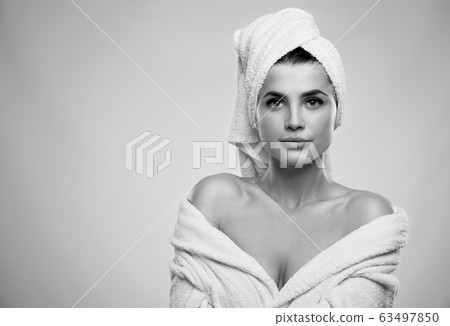 Monochrome portrait of woman in bathrobe. 63497850