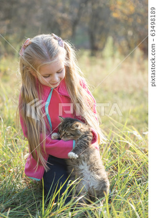 Child holding little kitten Child holding little kitten 63498189