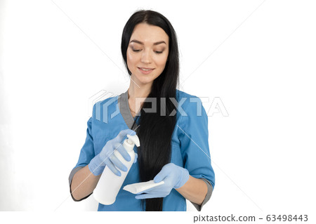 female doctor holding and about to use a liquid soap - isolated on white 63498443