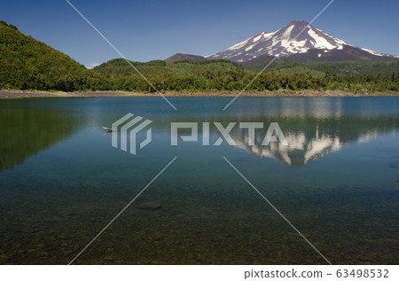 Llaima volcano reflected on the Conguillio lake. Llaima volcano reflected on the Conguillio lake. 63498532