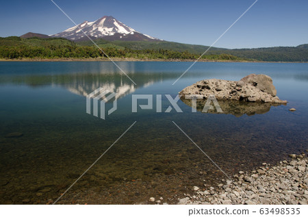 Llaima volcano reflected on the Conguillio lake. Llaima volcano reflected on the Conguillio lake. 63498535