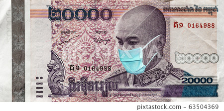 Coronavirus in Cambodia. Quarantine and global recession. 20000 Riel banknote with a face mask against infection. Global economy hit by corona virus covid19 outbreak and pandemic. Coronavirus in Cambodia. Quarantine and global recession. 20000 Riel banknote with a face mask against infection. Global economy hit by corona virus covid19 outbreak and pandemic. 63504369