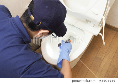 House cleaning male worker cleaning toilet 63504545