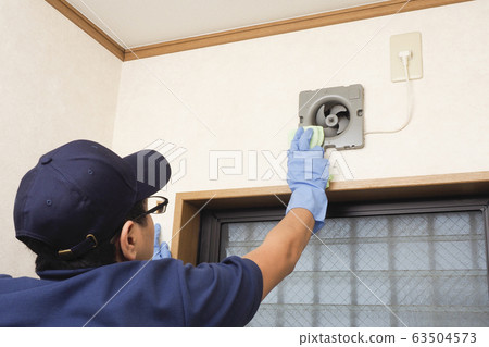 House cleaning male worker cleaning toilet ventilation fan 63504573