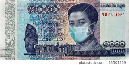Coronavirus in Cambodia. Quarantine and global recession. 1000 Riel banknote with a face mask against infection. Global economy hit by corona virus covid19 outbreak and pandemic.    63505229