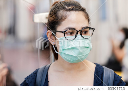 young Asian woman wearing Surgical face mask young Asian woman wearing Surgical face mask 63505713