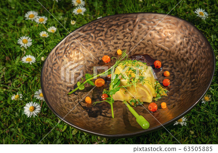 fresh spring appetizer with cheese and herbs served on green grass with flowers, product photography for restaurant fresh spring appetizer with cheese and herbs served on green grass with flowers, product photography for restaurant 63505885