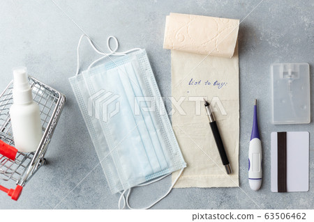 shopping list on toilet paper medical mask corona virus concept credit card small basket 63506462