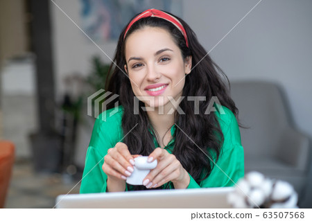 Successful young woman with a small box in her hands. Successful young woman with a small box in her hands. 63507568