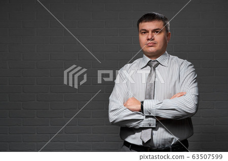 Businessman closeup portrait, dark wall background 63507599