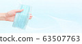 Medical mask in human hand. Banner design with abstract line background and clean space for your text 63507763