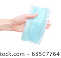 Medical mask in human hand. Isolated design on white background 63507764