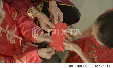 Giving red envelop for Chinese New Year Top view grandparent and five money to children Giving red envelop for Chinese New Year Top view grandparent and five money to children 63508815