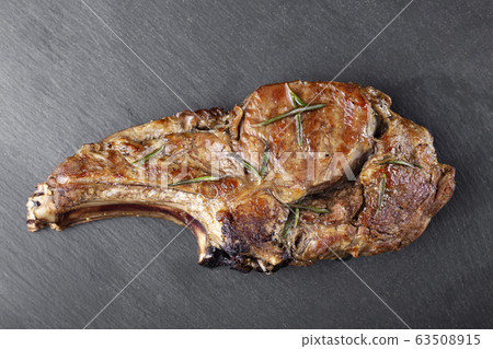 Steak on the bone. Tomahawk steak on a black 63508915