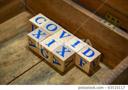 COVID-19. Wooden cubes with blue letters COVID-19. Wooden cubes with blue letters 63510117