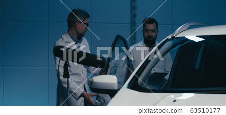Engineers working in test chamber 63510177