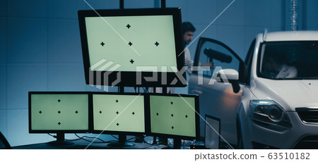 Engineers working in test chamber Engineers working in test chamber 63510182