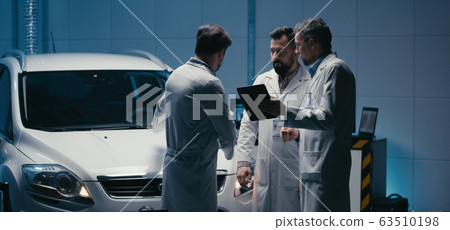 Engineers discussing in test chamber 63510198