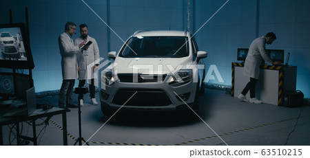 Engineers and robot working in test chamber Engineers and robot working in test chamber 63510215