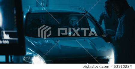 Engineers and robot working in test chamber Engineers and robot working in test chamber 63510224