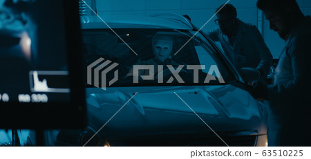Engineers and robot working in test chamber Engineers and robot working in test chamber 63510225